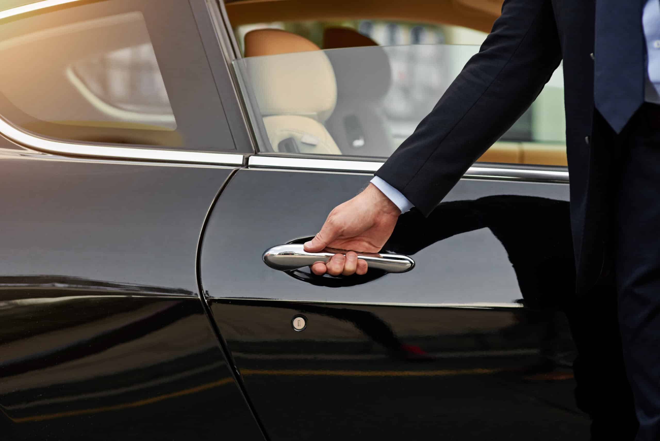Your ride is here...Cropped shot of an unrecognizable male chauffeur opening a car door.